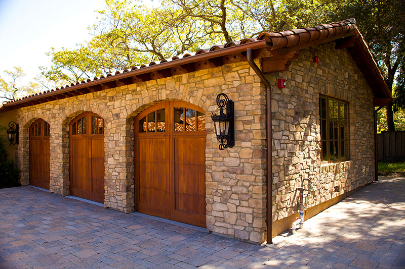 Wood Garage Doors on a stone wall garage - Garage Harmony